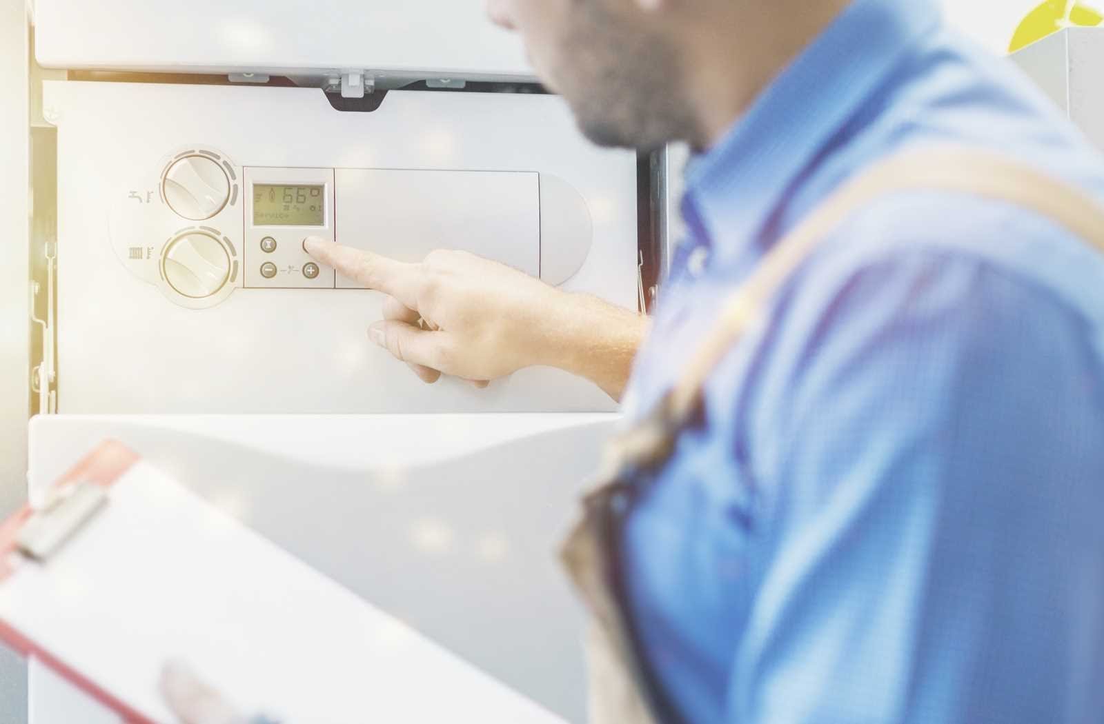 Technician adjusting the settings on a water heater