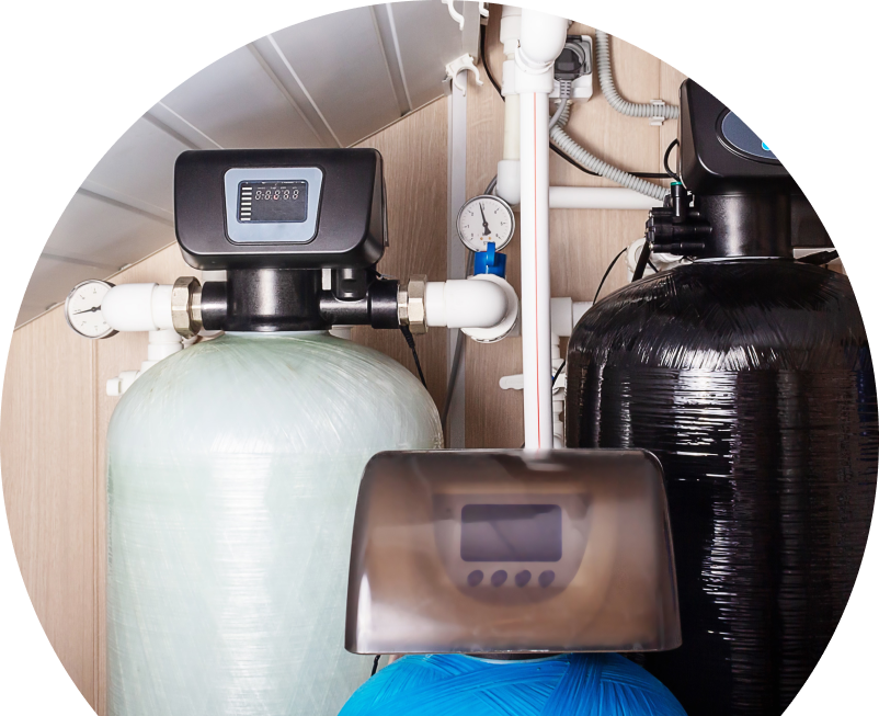 Shines home water filtration system featuring resin tanks, digital control heads, pressure gauges, and connected piping in a utility room.