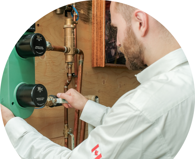 Shines HVAC specialist performing boiler installation, securing a valve on a new hydronic heating system with copper piping and a green circulation pump mounted on a wooden wall. Shines HVAC specialist performing boiler installation, securing a valve on a new hydronic heating system with copper piping and a green circulation pump mounted on a wooden wall.