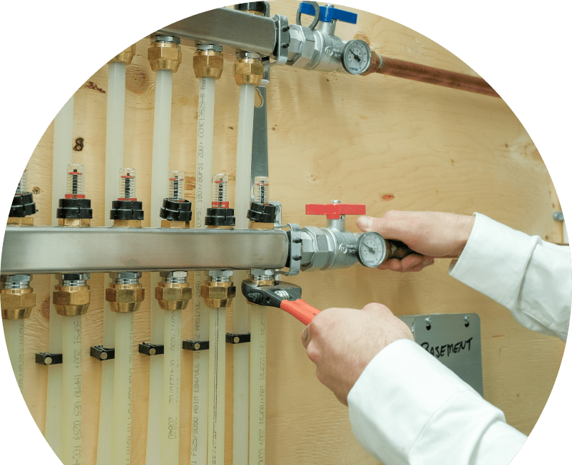 Shines HVAC specialist performing boiler repair, adjusting internal components of a residential unit with visible copper piping and control wiring.